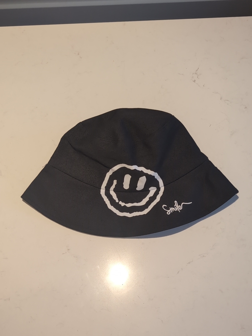 Black Bucket Hat with White Smile Graphic